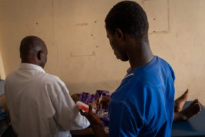 Abba and a nurse examining a pregnant woman.